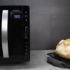 Imagen 3 Microondas sin plato de 23L con 800W y tecnología Flatbed. Dispone de 8 funciones preconfiguradas, panel táctil y temporizador de 95 min en elegante color negro.