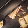 Imagen 5 Raclette Cheese&Grill 6000 Black de 600 W con función grill y acabados en acero inoxidable. Incluye parrilla antiadherente, termostato regulable y espátulas.