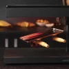 Imagen 7 Raclette Cheese&Grill 6000 Black de 600 W con función grill y acabados en acero inoxidable. Incluye parrilla antiadherente, termostato regulable y espátulas.